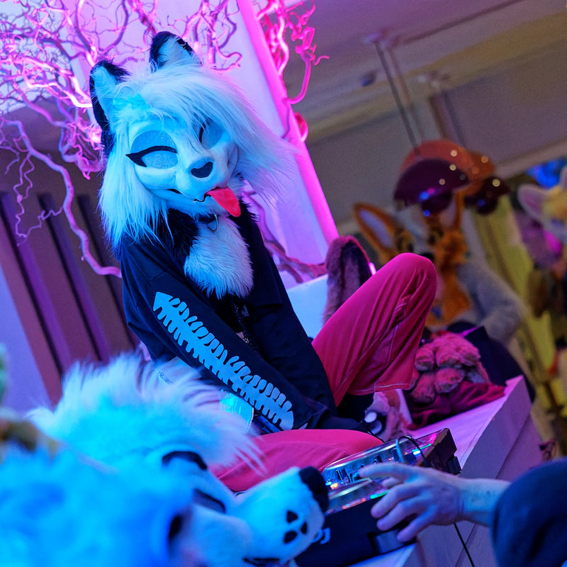 Person in a costume with animal head design interacting with others in a sky bar in Paris. Demon Akoy Costume. 