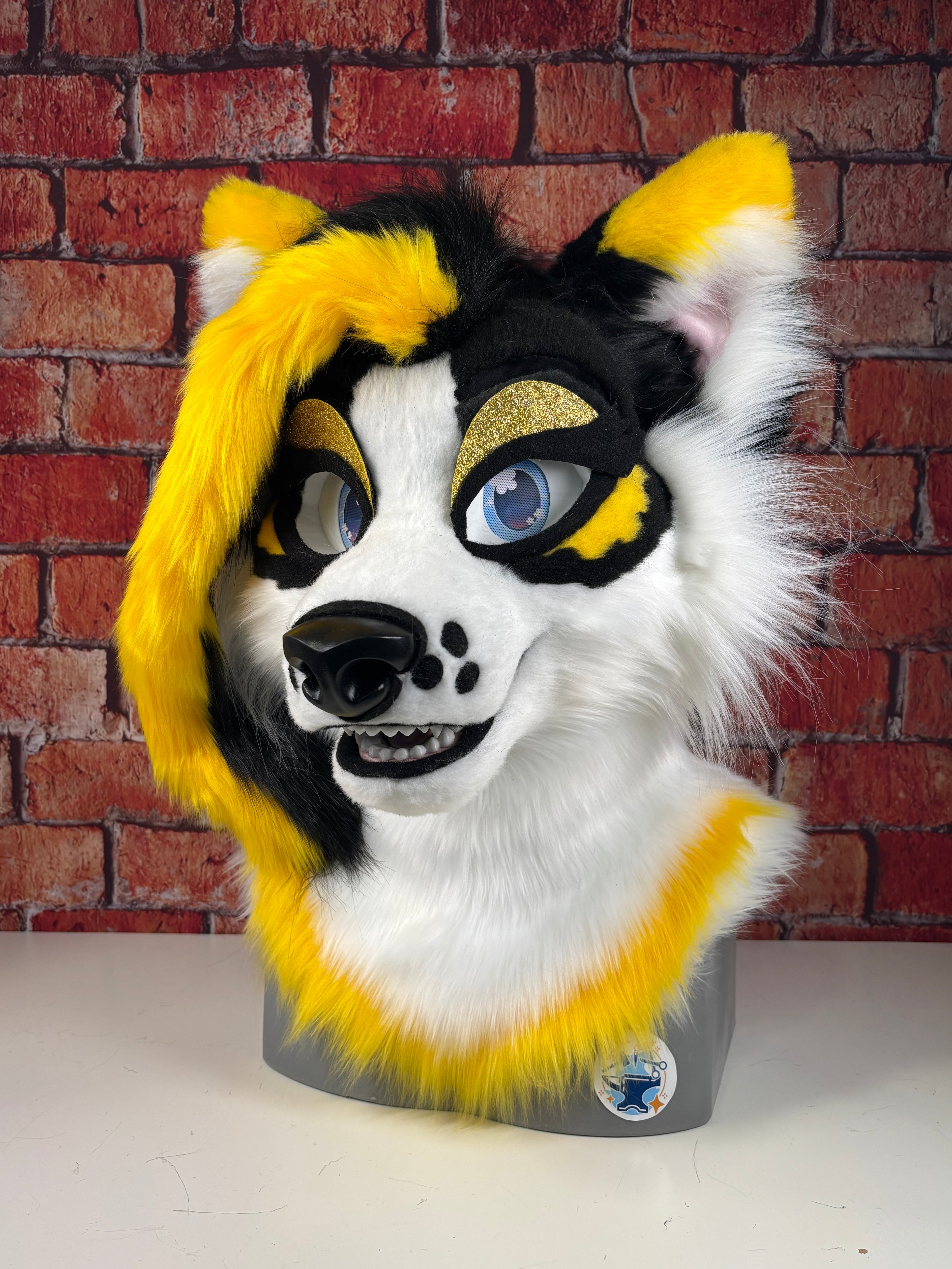 Furry mask with yellow, black, and white colors on a textured wall background. Daffodil fursuit head. 