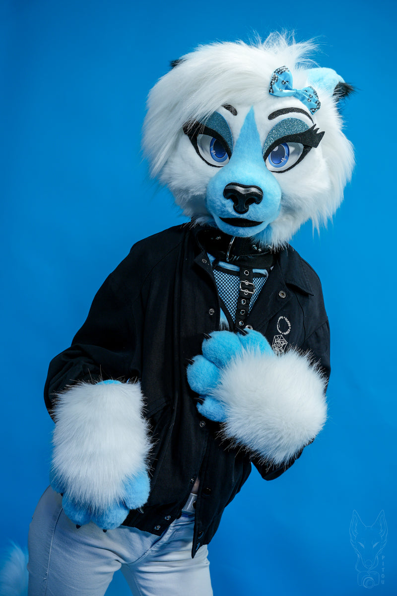 Person wearing a blue and white fur suit with a blue background